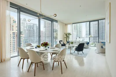 Luxurious open-plan living and dining area with stunning city views and modern decor.