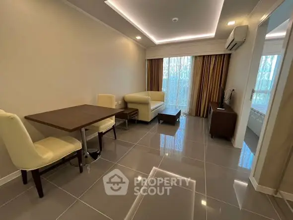 Modern living room with sleek tile flooring, stylish furniture, and ambient lighting.