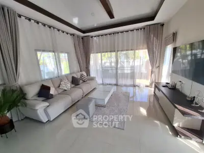 Spacious modern living room with large windows and elegant decor