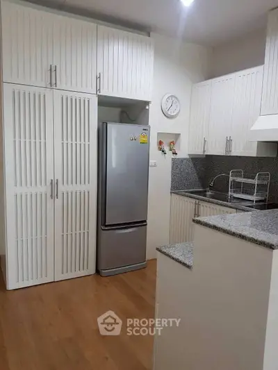 Modern kitchen with sleek cabinets and stainless steel fridge