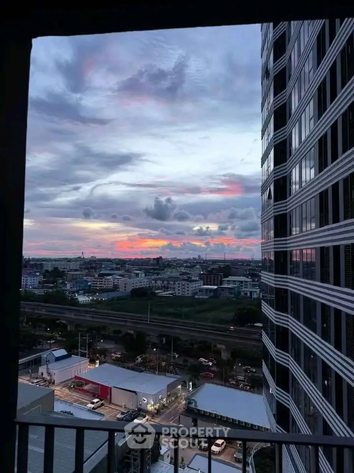 Stunning cityscape view from high-rise balcony at sunset