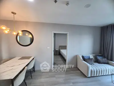 Modern living room with elegant dining area and cozy sofa, featuring stylish decor and soft lighting.