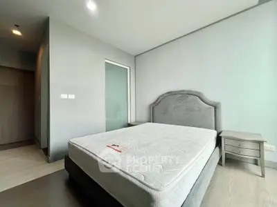 Spacious bedroom with modern design and comfortable bed in a stylish apartment.
