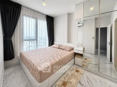 Modern bedroom with large window and mirrored wardrobe in a high-rise apartment.