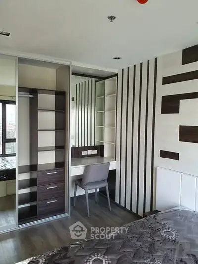 Modern bedroom with stylish built-in wardrobe and study area