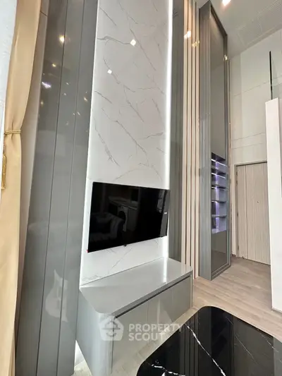 Modern living room with sleek TV unit and high ceilings in luxury apartment