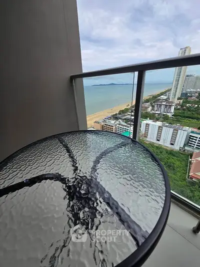 Stunning balcony view overlooking the ocean and city skyline, perfect for relaxation.
