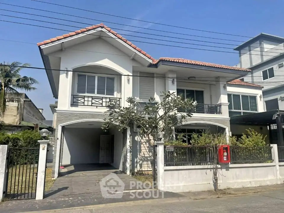 Charming two-story house with a spacious driveway and modern design, perfect for family living.