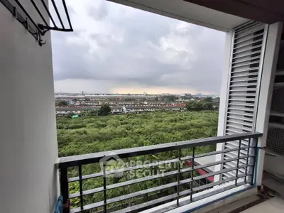 Stunning balcony view overlooking lush greenery and cityscape, perfect for relaxation and enjoying nature.