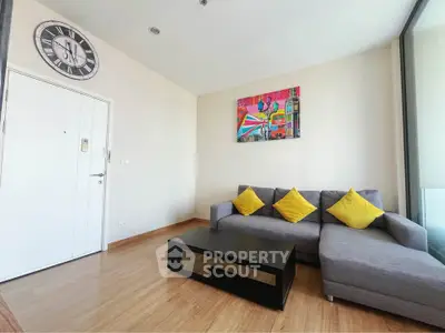 Modern living room with stylish decor and cozy seating in a bright apartment.