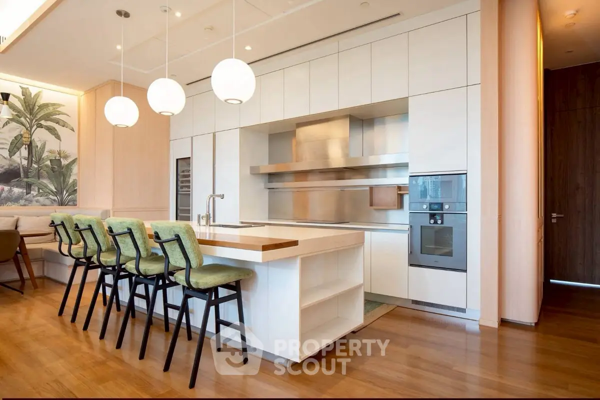 Luxurious modern kitchen with sleek design and high-end appliances, featuring an open layout and stylish bar seating.