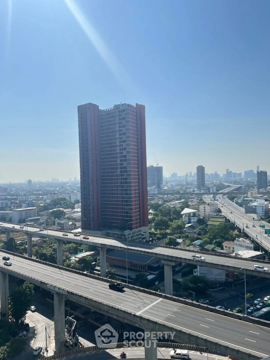 Stunning cityscape view with high-rise building and highway, perfect for urban living.
