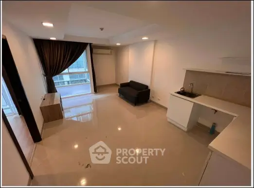 Spacious modern living room with sleek design and large window view