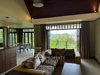 Spacious living room with large windows offering stunning views and cozy seating area.