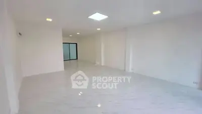 Spacious empty room with white walls and tiled floor, ideal for customization.