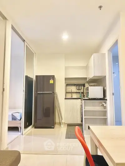 Modern kitchen with sleek appliances and open layout in a cozy apartment