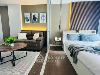 Modern studio apartment with stylish decor, featuring a cozy living area and comfortable bed.