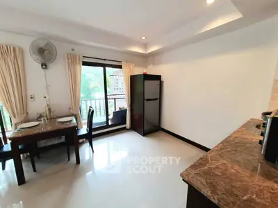 Spacious kitchen with dining area and balcony view in modern apartment