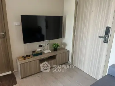 Modern living room with wall-mounted TV and stylish wooden cabinet
