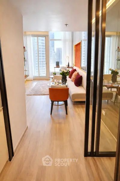 Modern living room with city view, stylish decor, and cozy seating area.