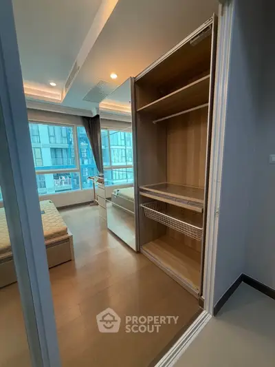 Modern bedroom with built-in wardrobe and large window view