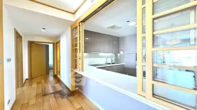 Spacious kitchen with open layout and wooden flooring in modern apartment