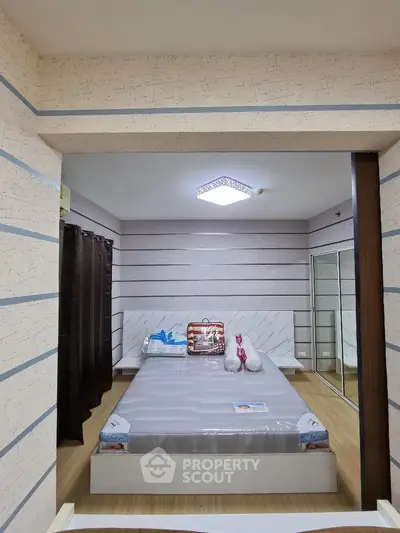 Modern bedroom with stylish decor and mirrored wardrobe
