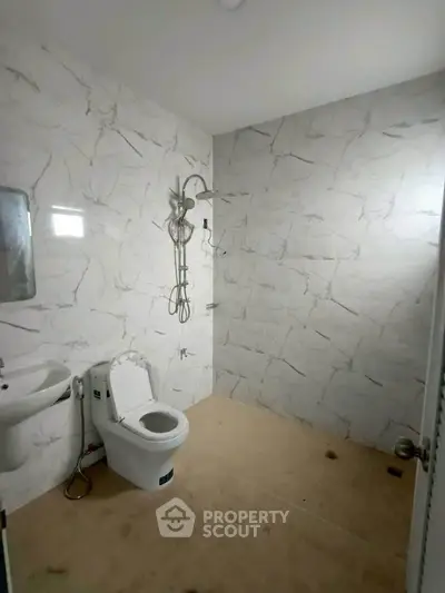 Modern bathroom with marble walls and sleek fixtures
