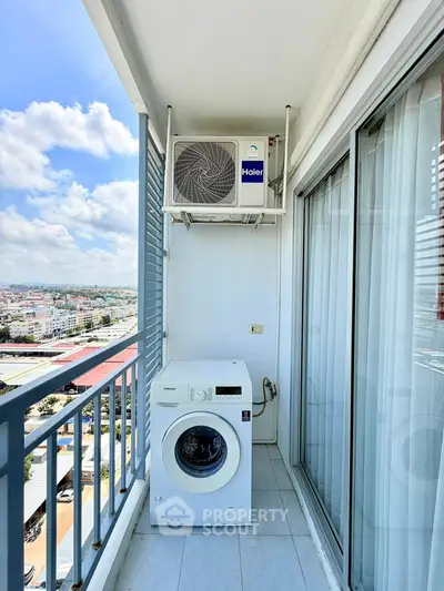 High-rise balcony with washing machine and city view, perfect for urban living convenience.