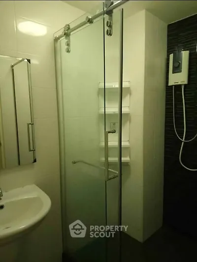 Modern bathroom with glass shower enclosure and sleek fixtures