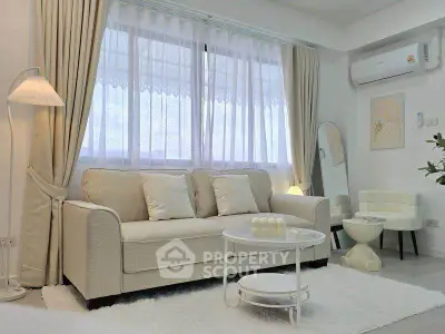 Elegant living room with cozy sofa and chic decor in bright natural light.