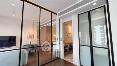 Modern apartment interior with sliding glass doors and stylish kitchen