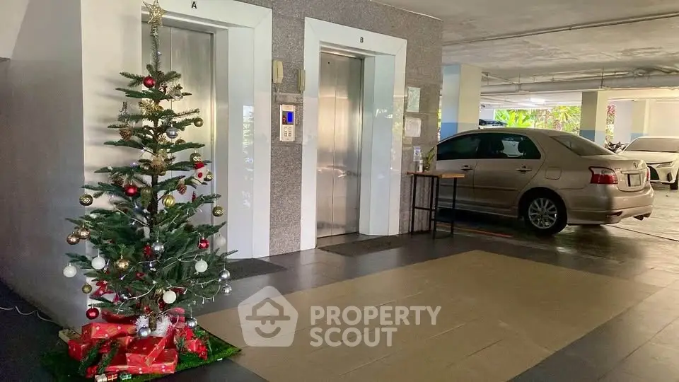 Festive parking area with elevators and decorated Christmas tree