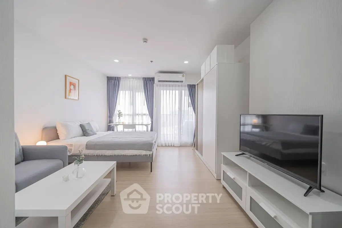 Modern studio apartment with cozy living area and natural light