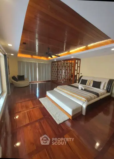 Luxurious bedroom with wooden flooring and modern decor