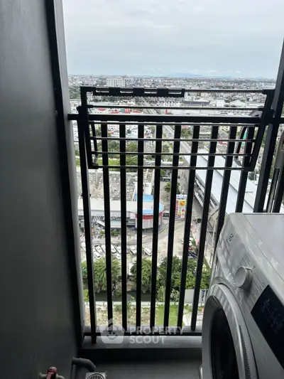 High-rise apartment balcony with city view and washing machine