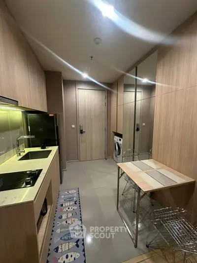 Modern kitchen with sleek design, featuring built-in appliances and stylish dining area.