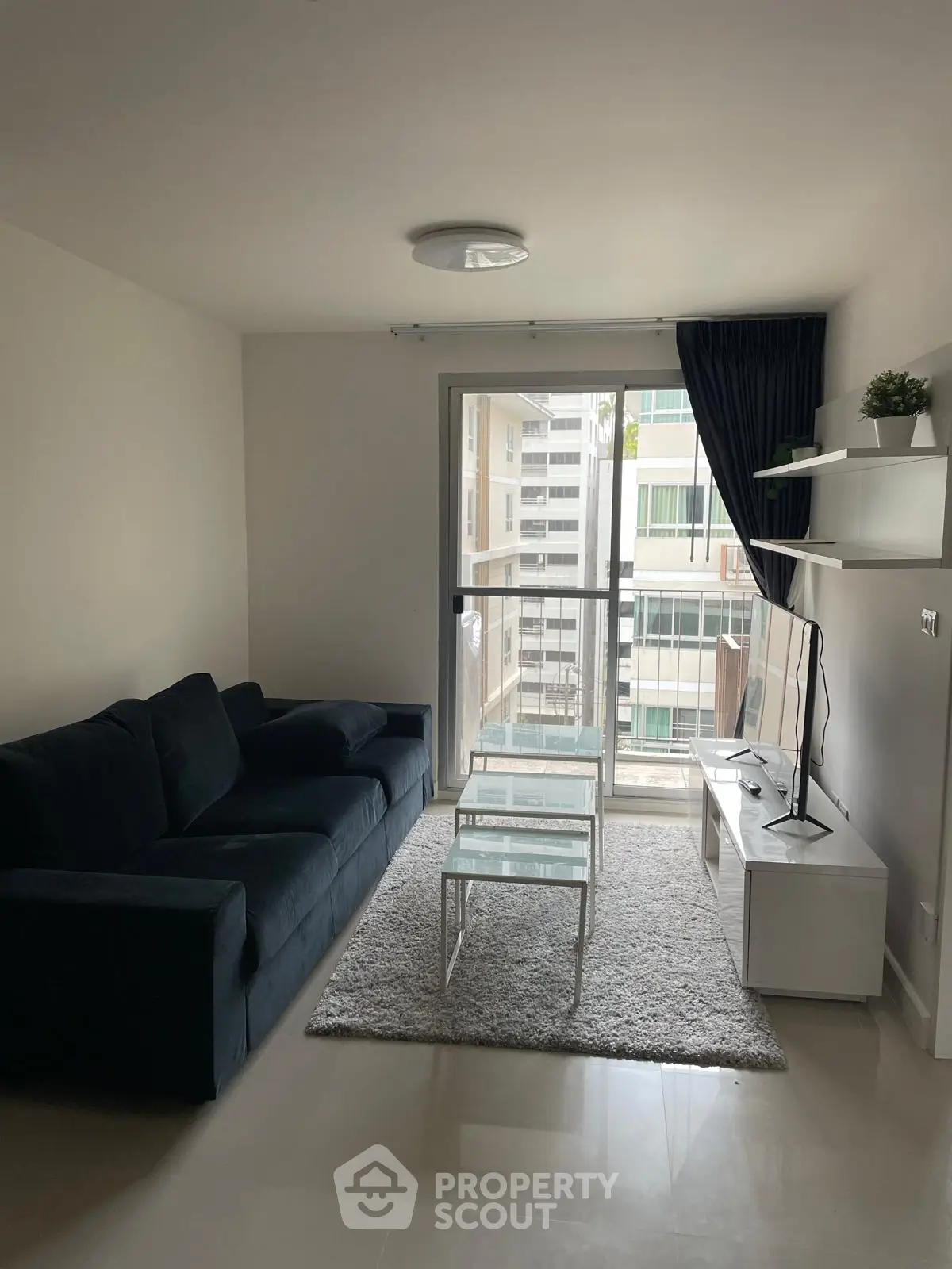 Modern living room with sleek furniture and large window view
