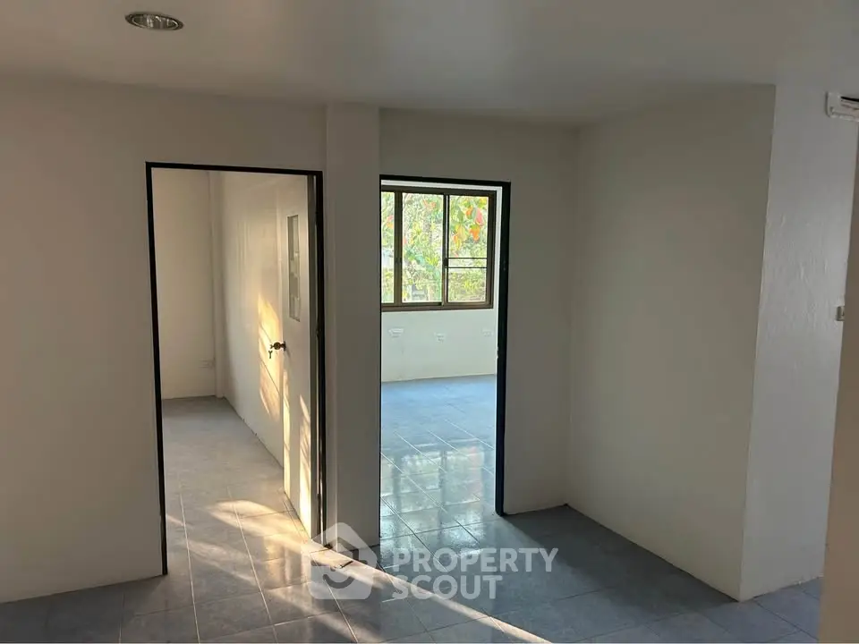 Spacious interior with natural light and tiled flooring, ideal for customization.