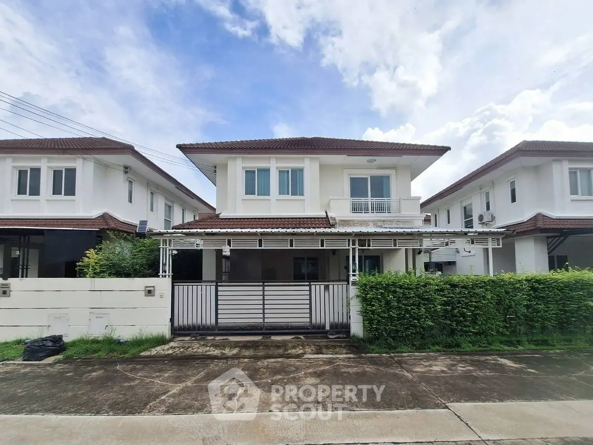 Charming two-story house with modern design and lush greenery in a serene neighborhood.