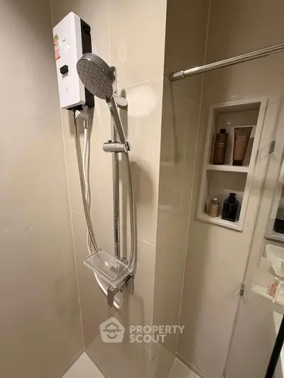 Modern bathroom with sleek shower and built-in toiletries shelf, perfect for contemporary living.