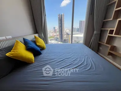 Modern bedroom with city view and colorful pillows