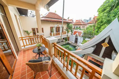 Charming balcony with traditional architecture and lush greenery view