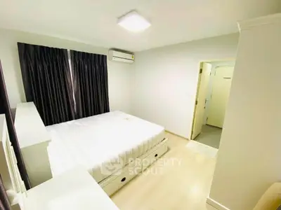 Bright and cozy bedroom with modern furnishings and ample natural light.