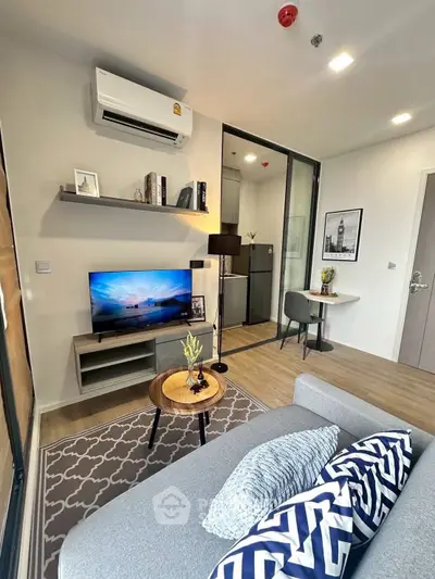 Modern living room with stylish decor, air conditioning, and cozy seating area in a contemporary apartment.