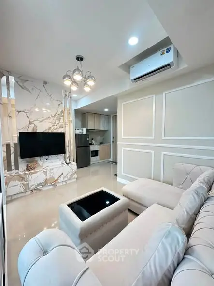 Luxurious living room with elegant marble accents and modern furnishings in a stylish apartment.