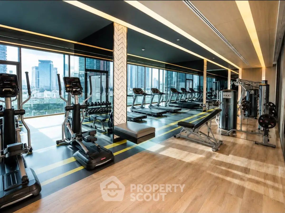 Luxurious high-rise gym with modern equipment and stunning city views.