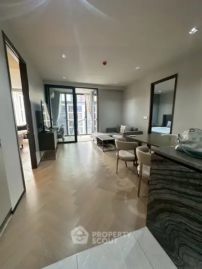 Modern living room with sleek design and large windows in a luxury apartment.