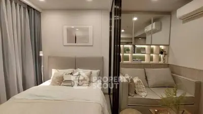 Modern bedroom with cozy seating area and stylish decor