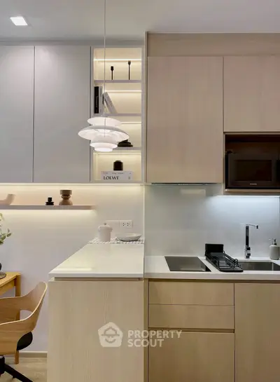 Modern kitchen with sleek cabinetry and integrated appliances in a stylish apartment.